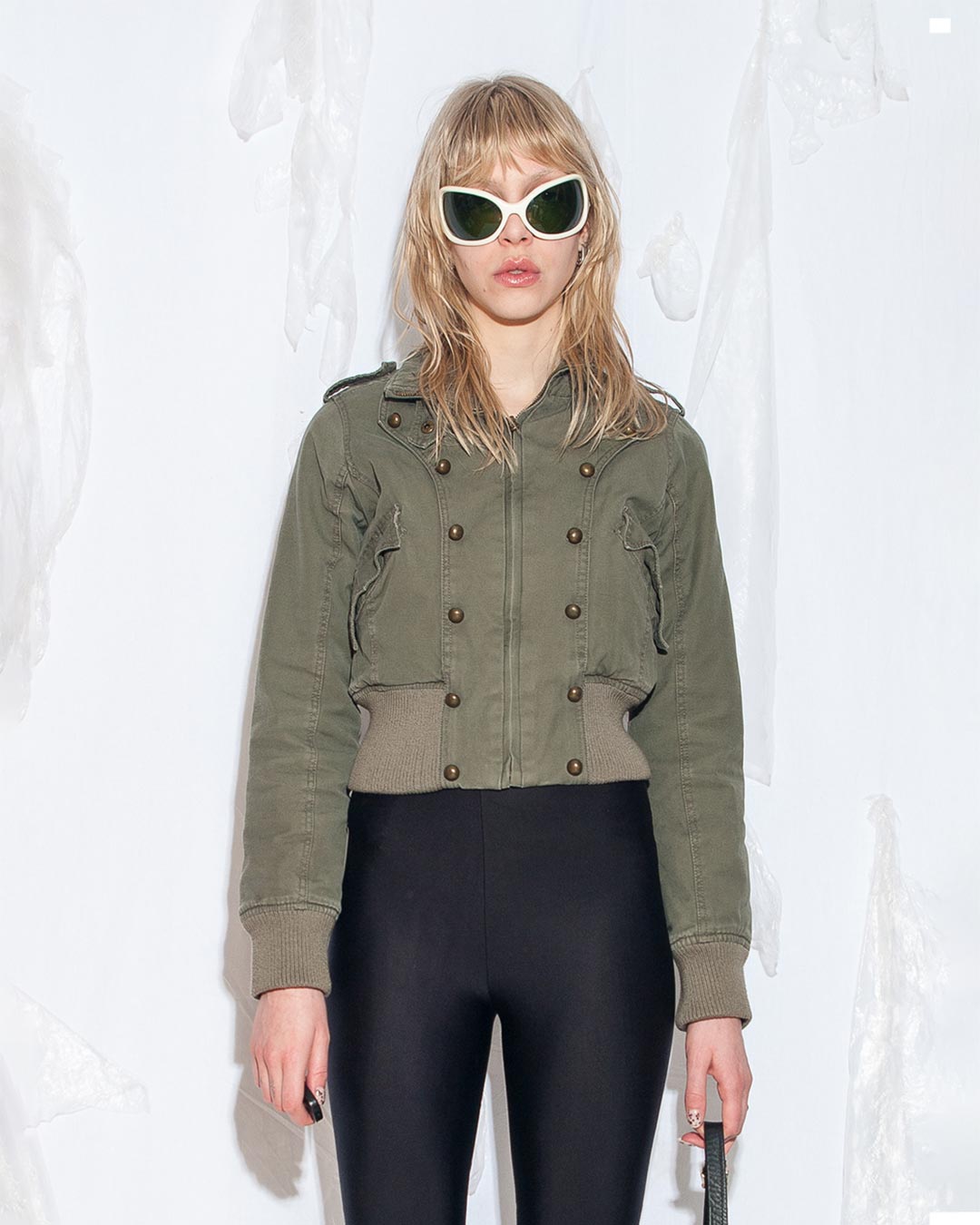 Photo of a female model wearing military style vintage jacket